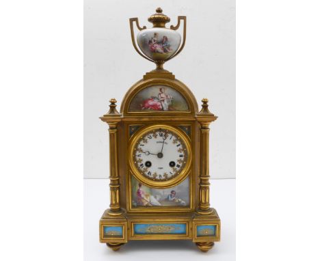 A 19th century French gilt-metal-mounted and porcelain eight-day mantle clock: the domed top decorated with a recumbent femal