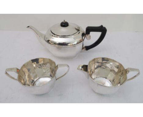 A hallmarked silver three-piece tea-service comprising teapot, milk jug and two-handled sugar. The teapot and jug assayed Bir