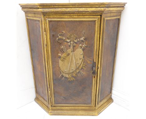 A good late 19th/early 20th century painted hanging corner cupboard: the central door painted with brushes and palettes alleg