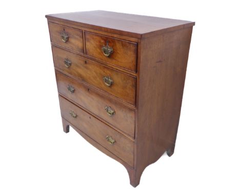 An early 19th century mahogany chest: two half-width over three full-width graduated drawers with brass handles, shaped apron