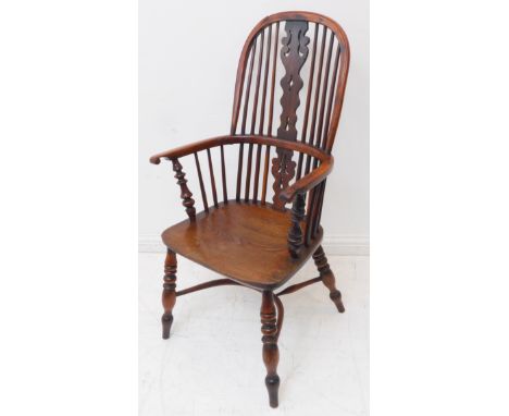 A mid-19th century comb-back Windsor armchair of good colour and large proportions: yew wood bows and pierced splat above sha