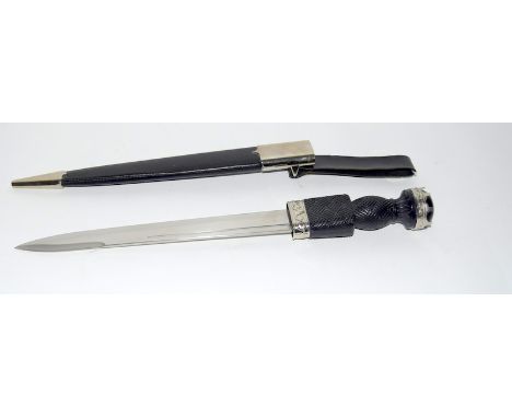 A good quality reproduction Scottish dirk in its scabbard. Blade length 28cms