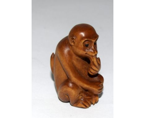 Wooden Japanese Netsuke in the form of a monkey signed to the base