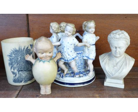 A German porcelain candle holder, a Victorian blue and white transfer printed mug with barley decoration, a Kewpie doll figur