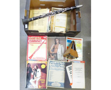 A Cor-ton clarinet, metronome (lacking cover) and sheet music 