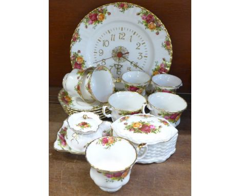 A collection of Royal Albert Old Country Roses china, five cups and saucers, clock, two vases, bowl and two lidded pot 