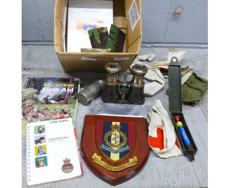 A box containing Royal Army Medical Corps badges, Regimental plaque, training materials, equipment, booklet, etc. 