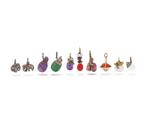 A GROUP OF NOVELTY EGG PENDANTS Comprising two eggs with hatching or hatched chicks; an enamel basket with a coral egg; a bun