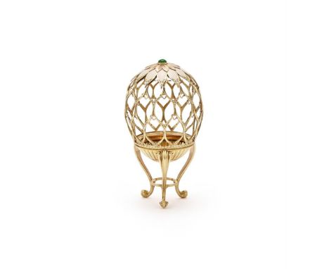 EDWARD EVANS, AN ENAMEL AND DIAMOND SET EGG STAND Designed as an openwork egg on three curved legs with guilloché enamel and 