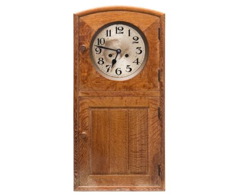 Heal and Son, an oak 'arts and crafts' wall clock: the eight-day duration movement striking the hours on a gong, the round si