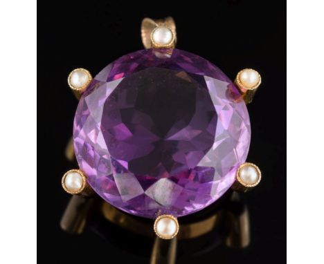 An Edwardian gold, amethyst and split seed pearl circular pendant: the circular amethyst 24mm diameter secured by six seed pe