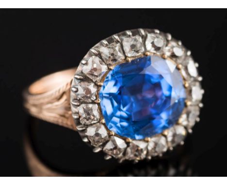 A Georgian foil backed sapphire and diamond cluster ring: the cushion-cut sapphire approximately 10.4mm long x 9.3mm wide, wi