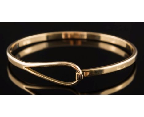 An 18ct gold torc-style bangle: with hook and loop terminal, 19gms gross weight.