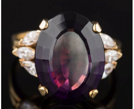 An amethyst and diamond oval cluster ring: the oval amethyst 17.8mm long x 13.2mm wide x 8.2mm deep in four claw setting, bet