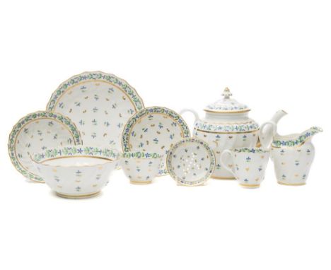 A Flight (Worcester) porcelain part tea service: of wrythen fluted form decorated with blue, yellow, green and gilt sprigs co
