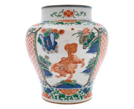 A Chinese porcelain jar enamelled in the Wucai palette: with three panels containing lion dogs and similar beasts bordered by