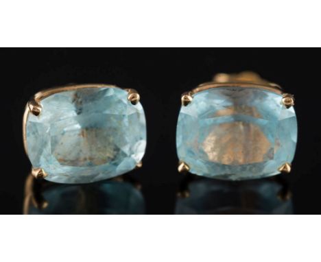 A pair of cushion-shaped aquamarine single-stone ear-studs: in four claw setting, stamped '14K', 2.5gms gross weight. 