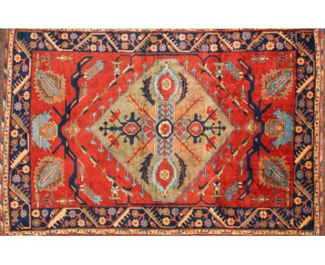 A contemporary Caucasian carpet:, of small size, the brick red field with a central pastel green lozenge medallion and geomet