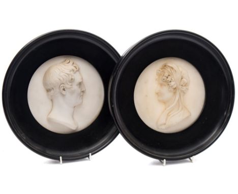 Joseph Gott [1786-1860]  A pair of relief carved marble portrait medallions of Mr and Mrs Benjamin Gott:  both signed 'J.Gott