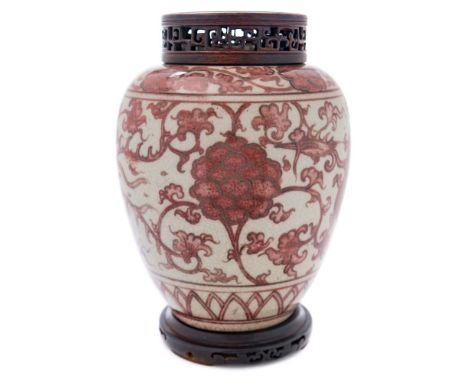 A Chinese porcelain jar: of oviform painted in copper red with phoenix and peony between lappet and peony scroll bands, with 