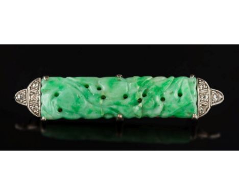A jade and diamond bar brooch: set with a pierced carved jade panel between millegrain set diamond clusters, 47mm long x 9.5m