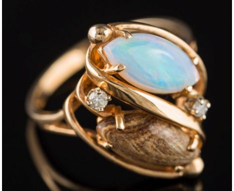 An opal and diamond mounted four-stone ring: with a marquise-shaped white opal  and similar opal matrix in a crossover design