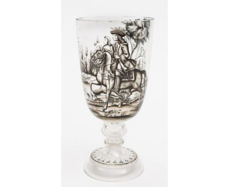 A German 'Historismus' glass goblet: enamelled in black monochrome with a continuous hunting scene, on a knopped stem and con