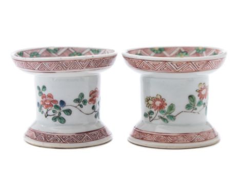 A pair of Chinese famille verte trencher pounce pots or sanders: painted with floral sprays and diaper borders, Kangxi, 7.5 c