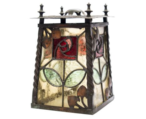 An Art Nouveau coppered metal hall lantern: the leaded coloured glass panels with flower head and scrollwork motifs between s