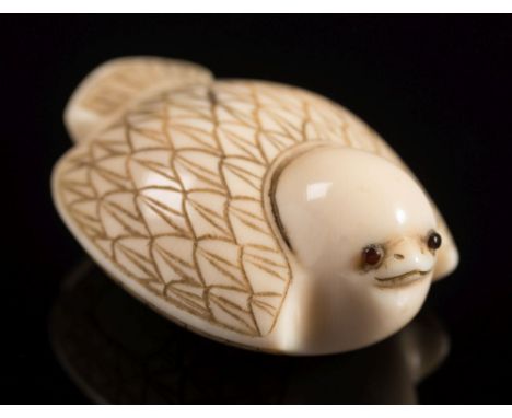 A Japanese carved ivory netsuke in the form of a sparrow: with folded wings and inset eyes, signed, Meiji period, 5cm. long.