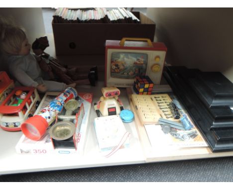 A shelf of mixed vintage toys and games including Tomy ET model, Fisher Price, tin plate scale etc