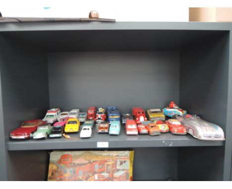 A shelf of tin plate and diecast playworn vehicles including Western Germany sports car, Japanese friction driven saloon car,