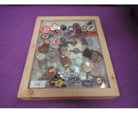 A glazed wooden case containg over 50 Enamel Badges including Speedway, Railway, Womens Legion etc