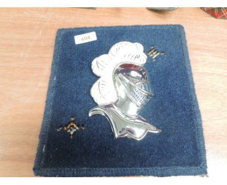 A motor car engine hood badge for Knight of the Road