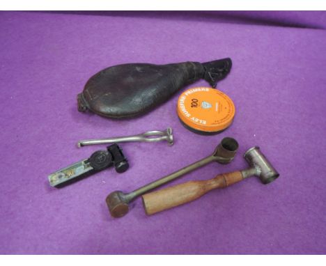 A leather and metal powder flask and powder measures