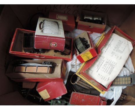 A shelf of TTR Trix rolling stock, accessories and track, with boxes and packets