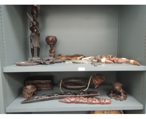 A carved African warrior and other carvings and decorative tribal items including box with napkin rings, wall plaques, treen 
