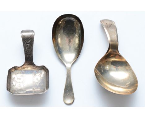 A George III silver bright cut caddy spoon, Birmingham 1809, another London 1803 and a third Sheffield 1919, 27gms. 