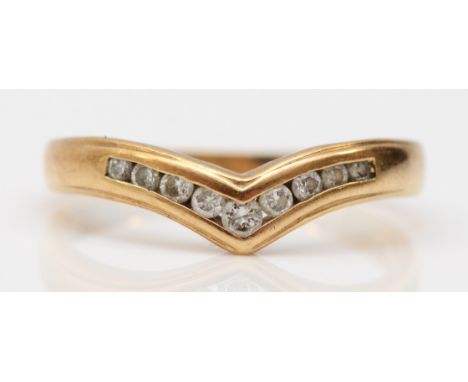 A 9ct gold and brilliant cut diamond channel set chevron ring, stated weight 0.20cts, N, 2.2gm 