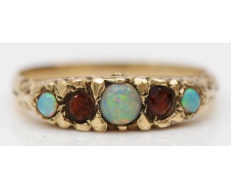 A vintage unmarked gold opal and garnet five stone ring, carved setting, N, 2gm 