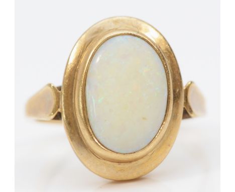 A 9ct gold and opal panel ring, stone, 14 x 9mm, R, 5.1gm, good colour play, surface abrasions, would benefit from a polish 
