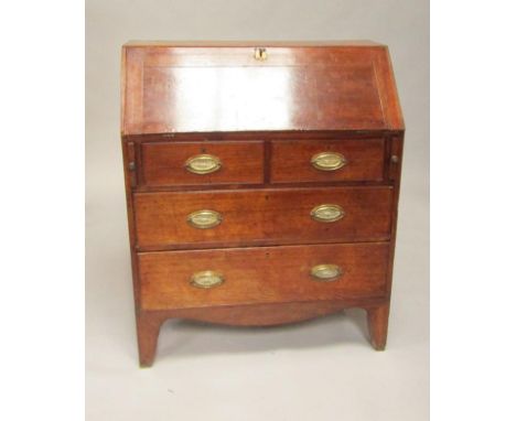 A George III oak bureau, the fall flap opening to reveal a mahogany interior of drawers and recesses flanking a satinwood cro