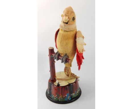 A Louis Marx branded parakeet automaton, with a CK Japanese branded dancing merry chimp automaton, 46cm and 33cm high respect