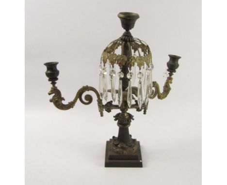 A French late 19thC bronze and brass three branch candelabra, the central stick with brass leaf spray supporting cut glass ch