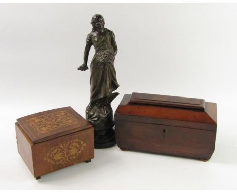 A Regency mahogany twin division sarcophagus tea caddy, raised on bun feet, 24cm x 12cm x 14cm, together with a music box and