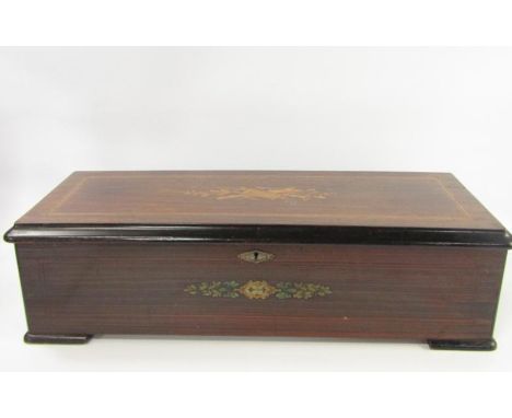 A Swiss walnut ebonised and inlaid music box, late 19thC, inlaid to the lid with musical instruments and oak leaves, playing 