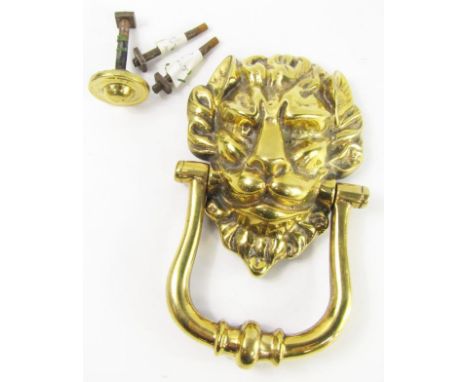 A brass lion's head door knocker, 19cm long.