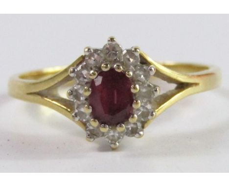 A ruby and diamond oval cluster ring, set in 18ct yellow and white gold, gross weight 2.95g.