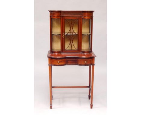 An Edwardian mahogany and boxwood line inlaid display cabinet, the straight and bow fronted top enclosing a shelf, over a fri