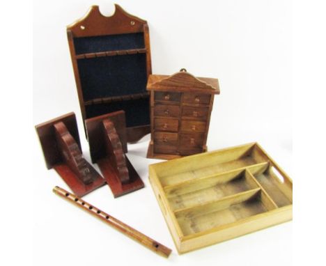 A hardwood miniature chest of nine drawers, a recorder, cutlery tray, pair of book ends and a spoon rack. (6)